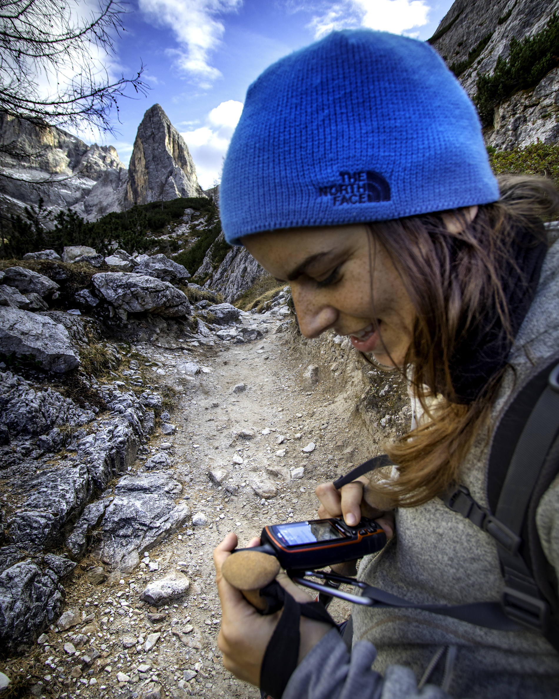 Woman looking at Garmin GPS in the Dolomites