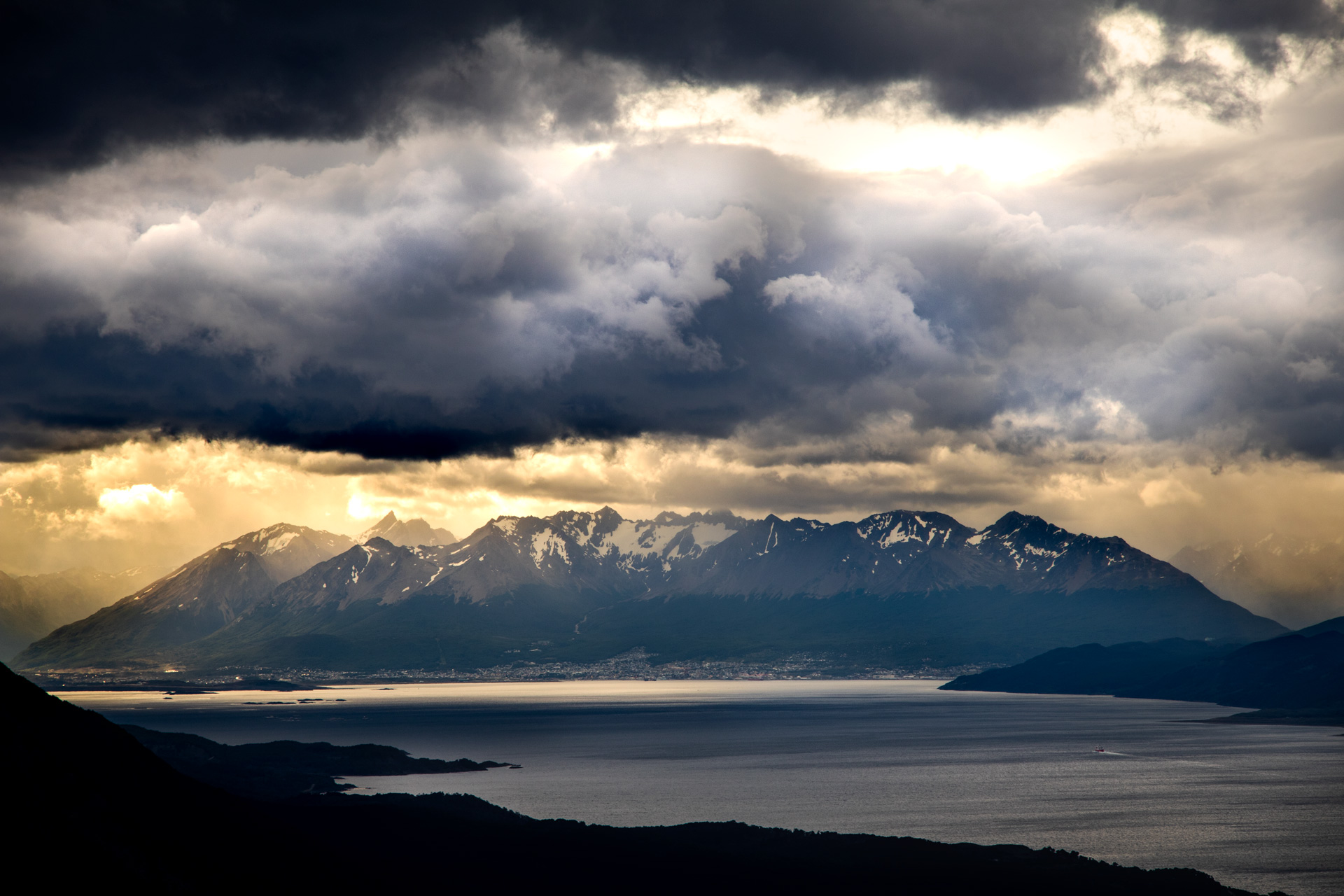 Outside-Material-Ushuaia-Sun-through-clouds-Mountains Sunset Ushuaia Sun through clouds Mountains