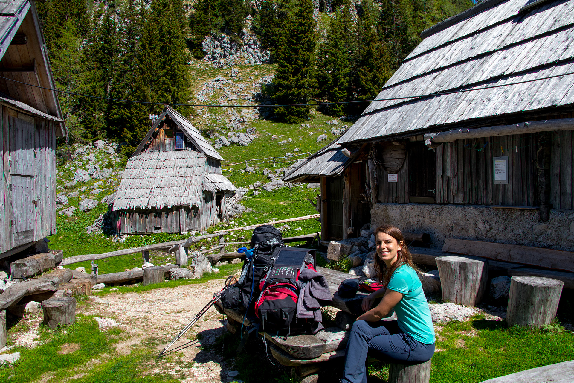 Outsidematerial_Julian_Alps_forest_village_break Woman sitting at Planina Viševnik / Mountain Pasture Visevnik