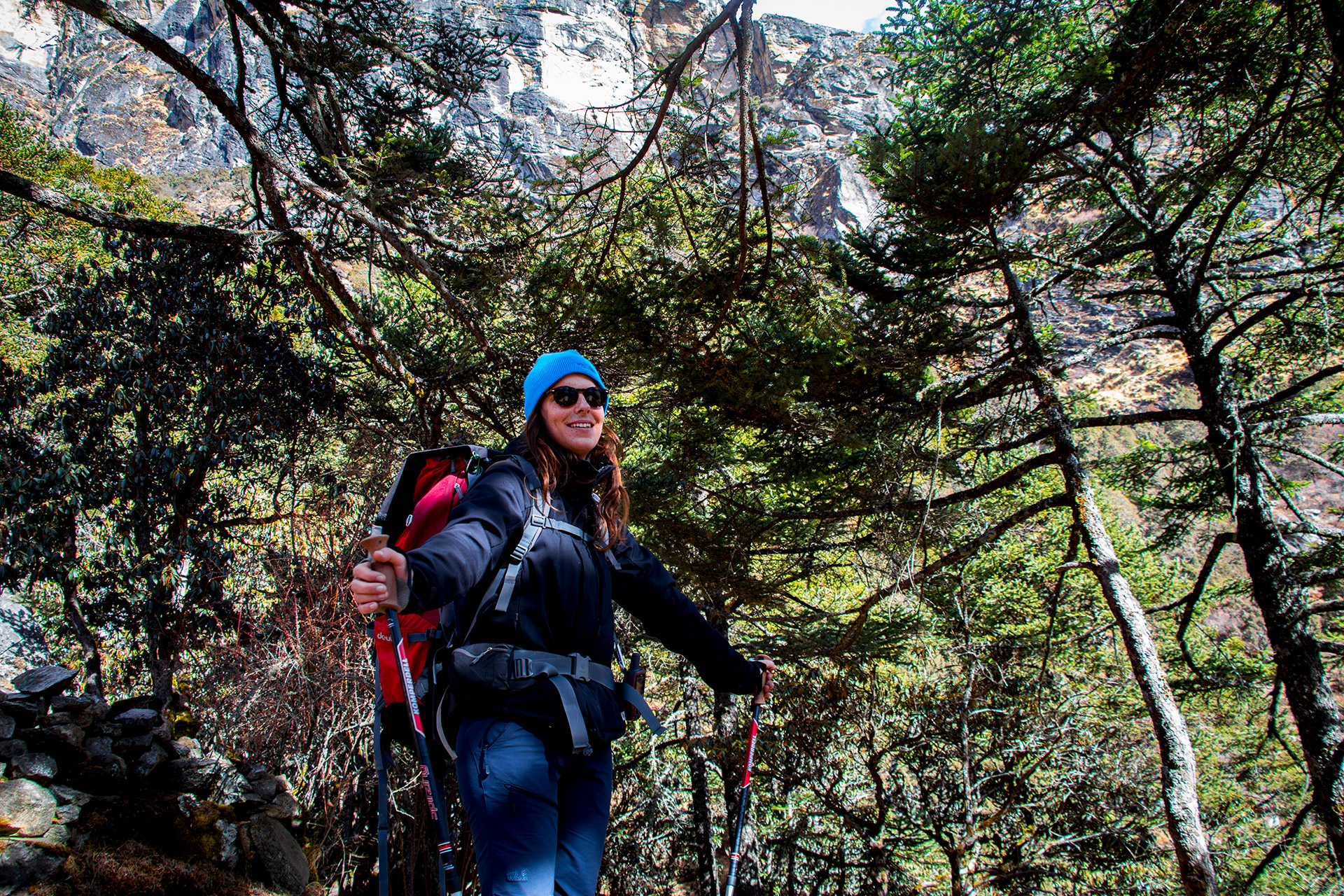 outsidematerial-nepal-ebc-everest-base-camp-trek-himalaya-smile-woman-hiker-backpack-forest